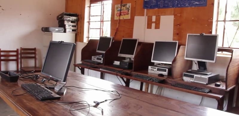Hadassah's small computer room, with a handful of old desktop computers on wooden tables.